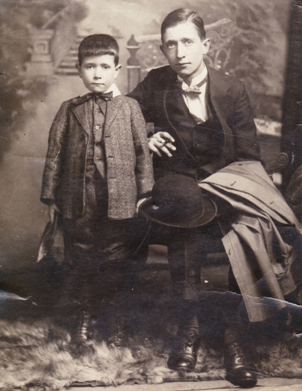 Olive's father, seated on the right